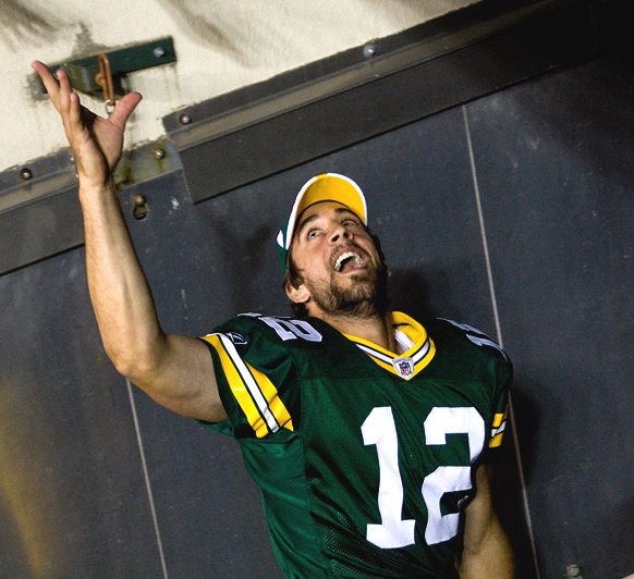 Green Bay Packers starting quarterback Aaron Rodgers runs off Lambeau Field into the tunnel amid a standing ovation.