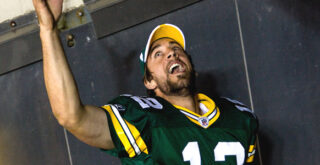 Green Bay Packers starting quarterback Aaron Rodgers runs off Lambeau Field into the tunnel amid a standing ovation.